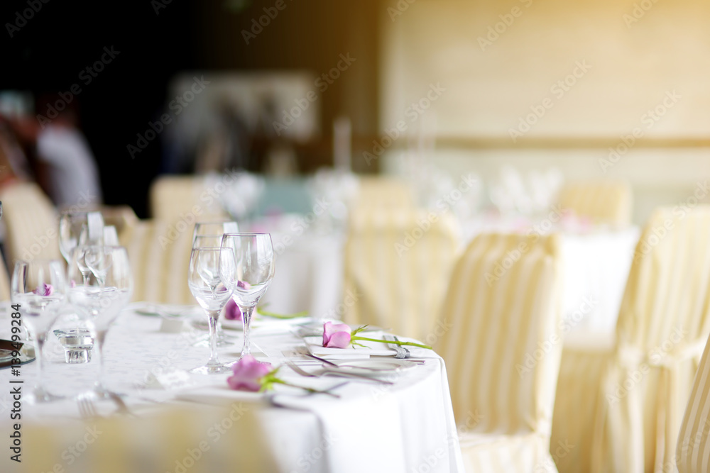 Beautiful table setting with crockery and flowers for a party, wedding reception or other festive event Beautiful table setting with crockery and flowers for a party, wedding reception or other festive event
