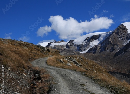 Curved gravel road in Zermatt. Findel glacier.