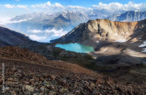 Emerald mountain lake. The lake is surrounded by mountains, huge rocks. Panorama Lake Syltrankel. Caucasus.
