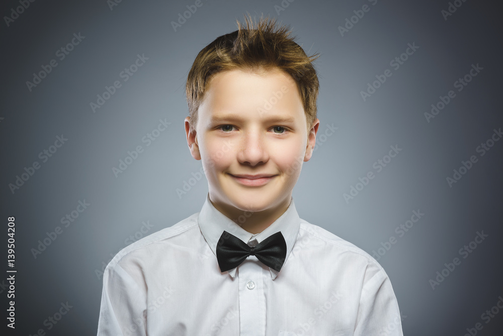 Happy child. Portrait of handsome boy smiling isolated on grey background Happy child. Portrait of handsome boy smiling isolated on grey background