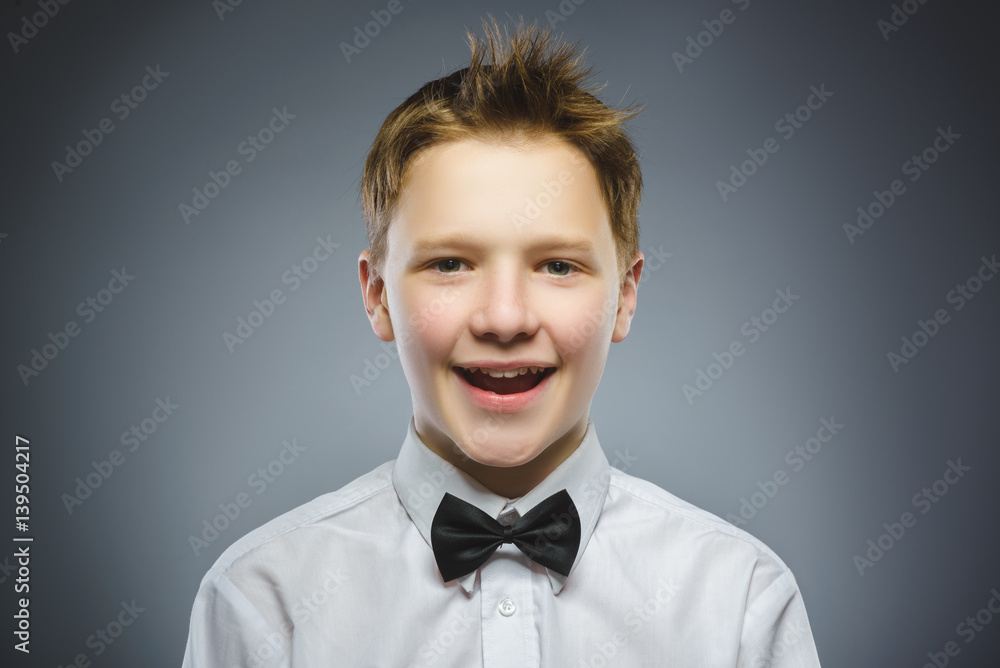 Happy child. Portrait of handsome boy smiling isolated on grey background Happy child. Portrait of handsome boy smiling isolated on grey background