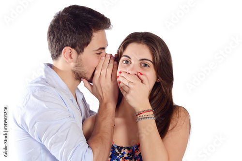 Man whispering to girlfriend.