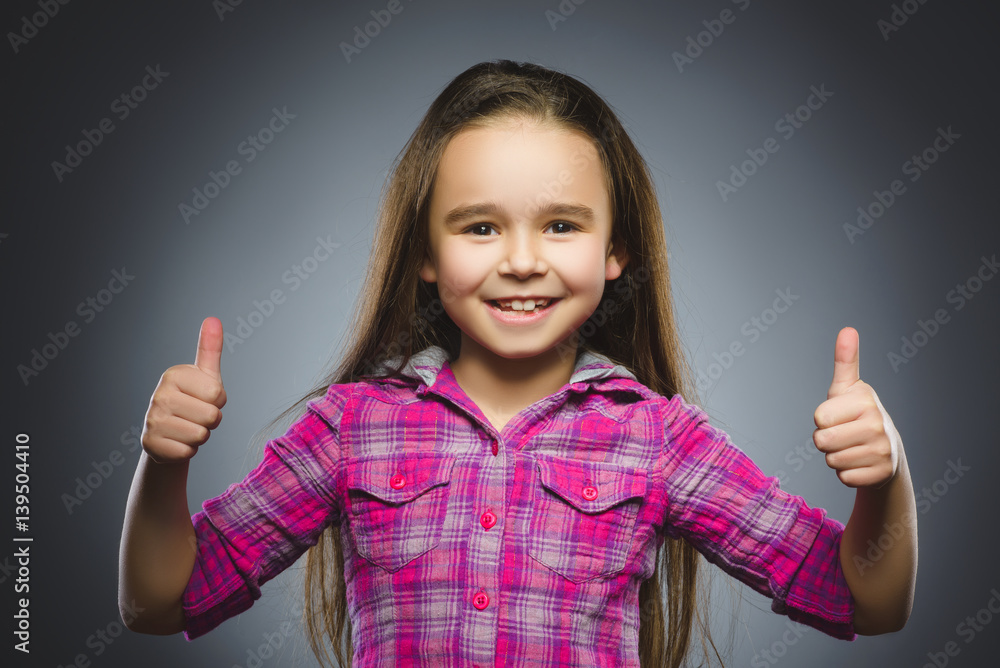 Closeup portrait successful happy girl show thumb up isolated grey background. Closeup portrait successful happy girl show thumb up isolated grey background.