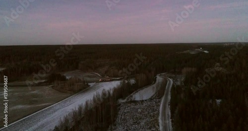 Snowy fields evevning, Cinema 4k aerial view of a flight above fields, at a snowy winter evening, in Kemiönsaari, varsinais-suomi, Finland photo