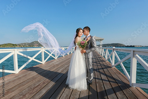 Pre Wedding photography thai couples on a wooden Atsadang bridge of Koh Si Chang Island at Thailand. photo