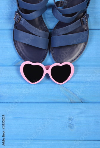 Sandals for woman and sunglasses for vacation and summer, copy space for text