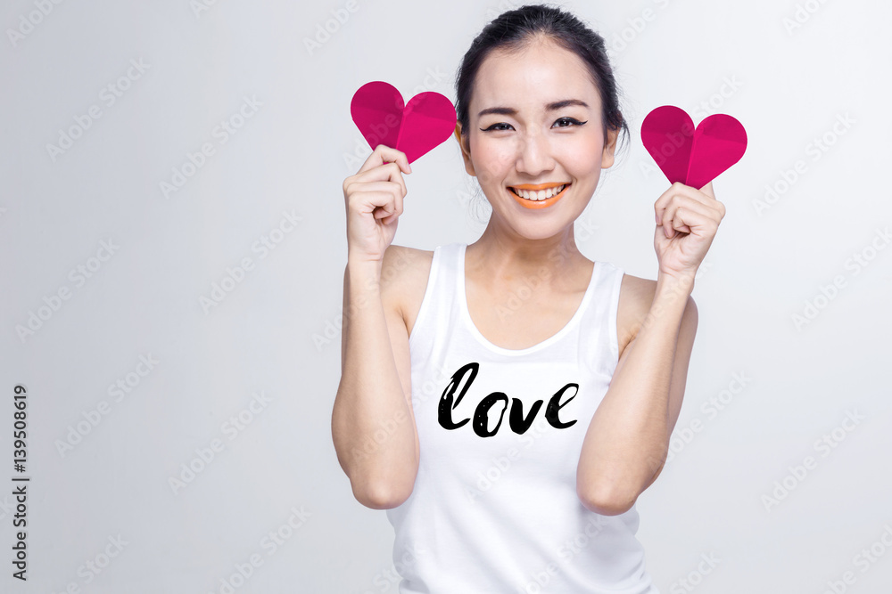 beautiful asian teen with white tshirt and red heart paper shape with love ideas concept on white background beautiful asian teen with white tshirt and red heart paper shape with love ideas concept on white background