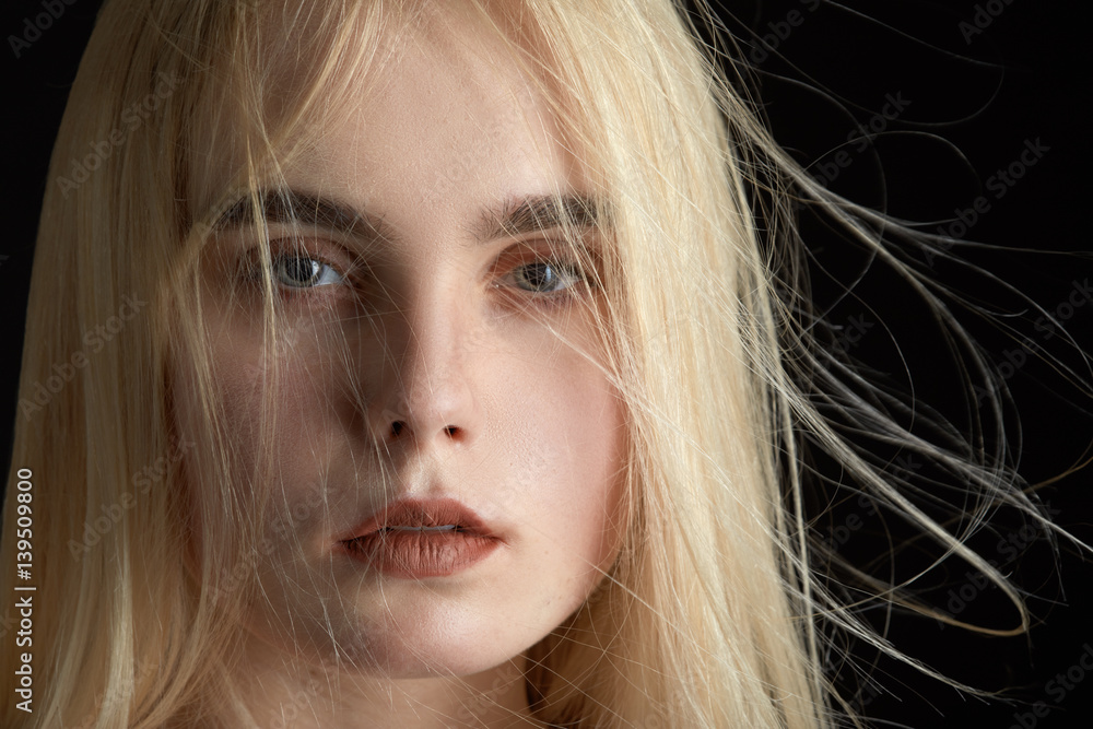 sensual blond girl with flying hair portrait on black background sensual blond girl with flying hair portrait on black background