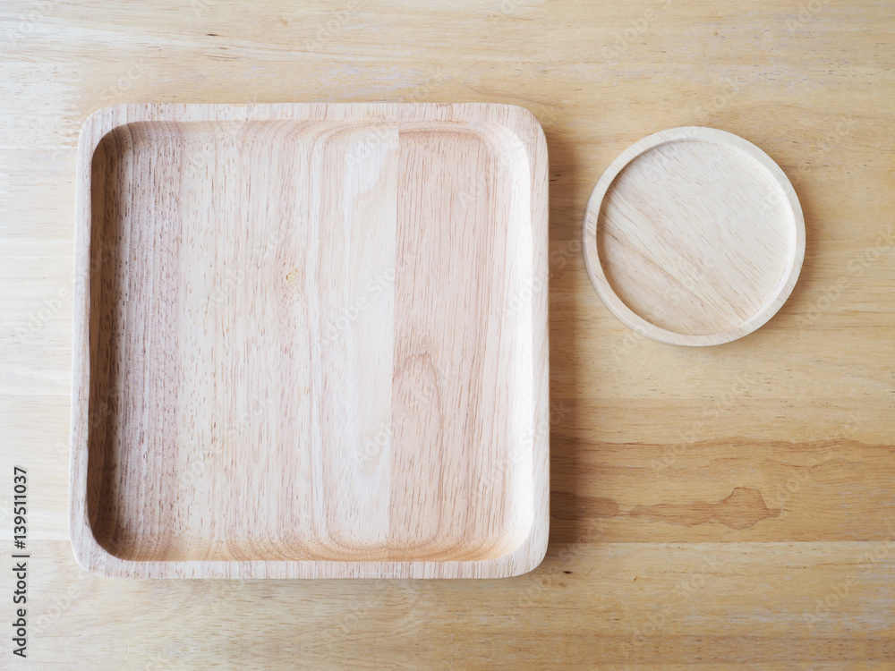 Wooden square and round plates on wood background Wooden square and round plates on wood background