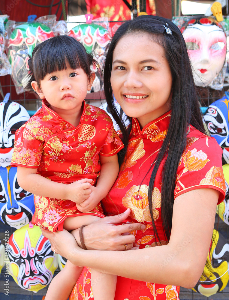 Happy Chinese new year, Cute Asian Girl smile and hug her child In