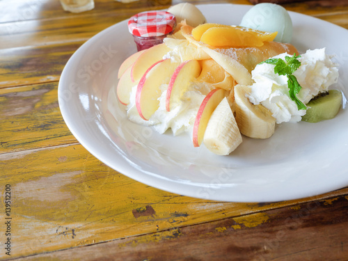 crepe with fresh fruit on wooden table