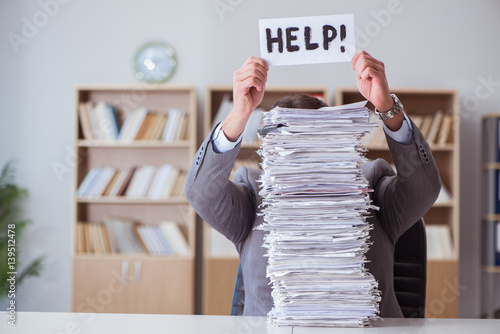 Businessman busy with paperwork in office photo