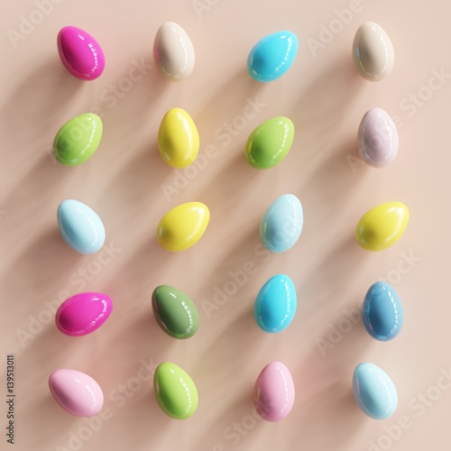 Colorfull eggs on pastel pink backgound. minimal concept. top view