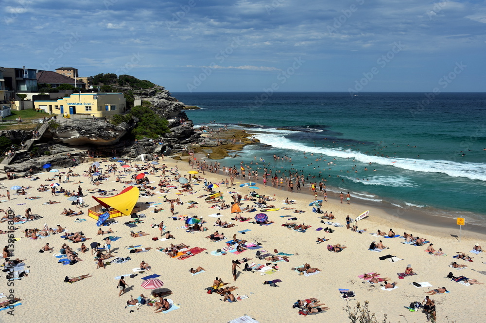 Sydney, Australia - Feb 5, 2017. People relaxing, swimming and sun bathing on Tamarama beach.