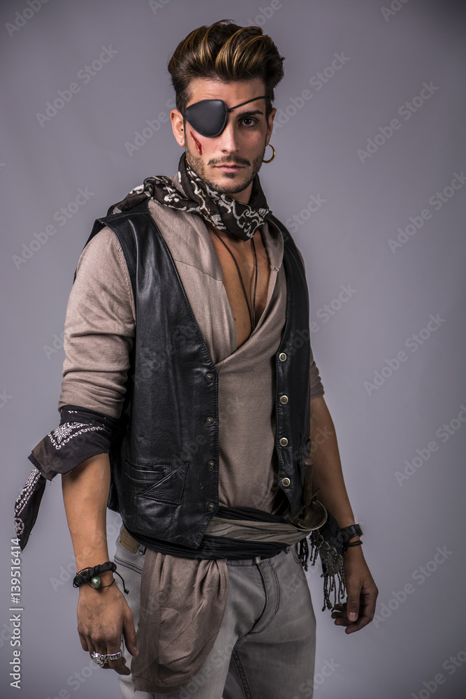 Good Looking Young Man in Pirate Fashion Outfit on Gray Background.  Captured in Studio. Photos | Adobe Stock