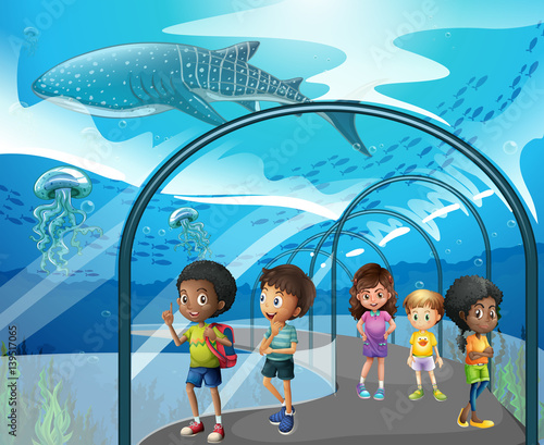 Children looking at fish in aquarium