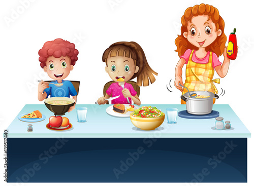 Mother and kids having meal at dining table