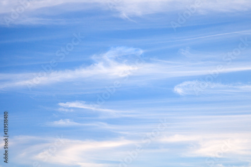 Light white cirrus clouds on blue sky, background