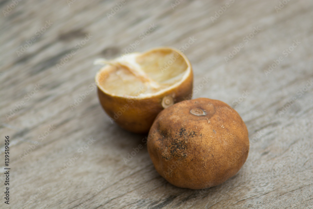 .Haggard ripe lemon drop on a brown wooden floors. Wood saw clear And the shape of a lemon. .Haggard ripe lemon drop on a brown wooden floors. Wood saw clear And the shape of a lemon.
