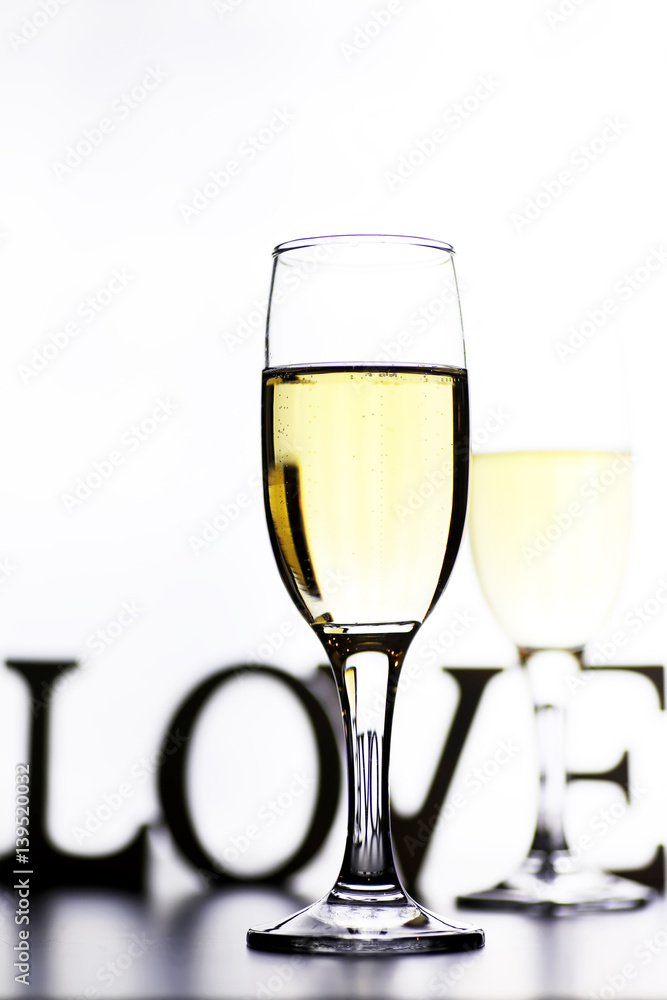 glass of white wine on a table on white background isolate glass of white wine on a table on white background isolate