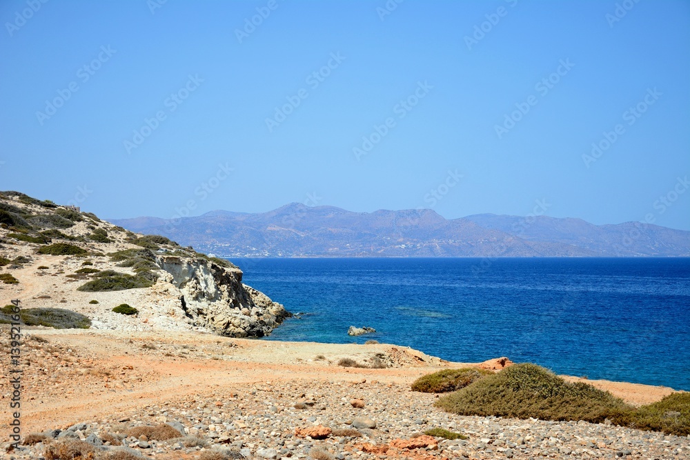 View of the beach and rugged coastline near Ammoudara, Crete.