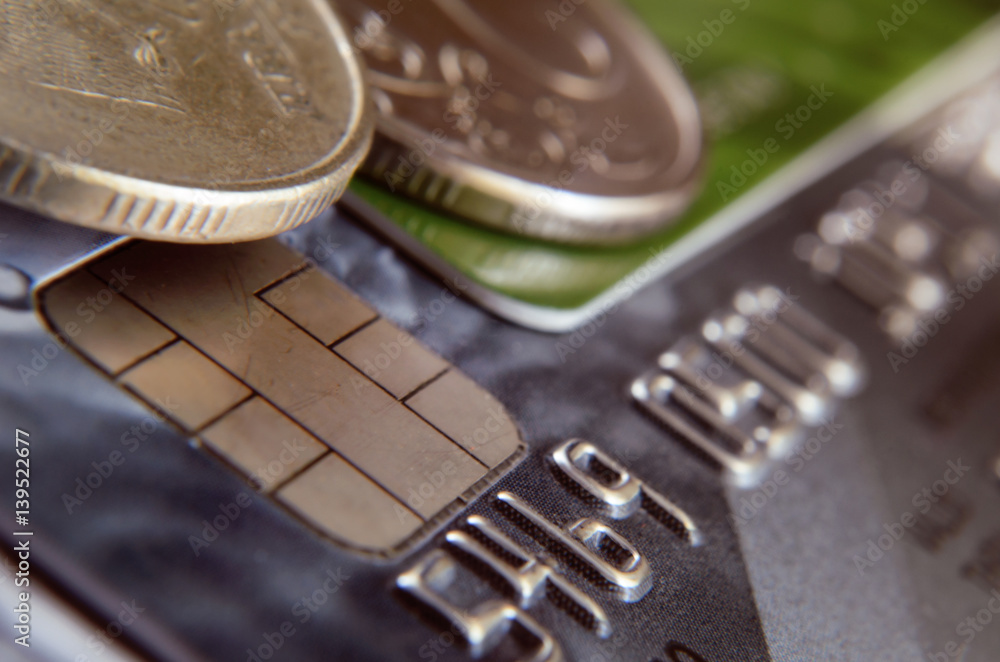 Close up of number of a bank card, chip and fragment of a coin. Close up of number of a bank card, chip and fragment of a coin.