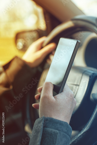 Driving car and using mobile phone to send text message