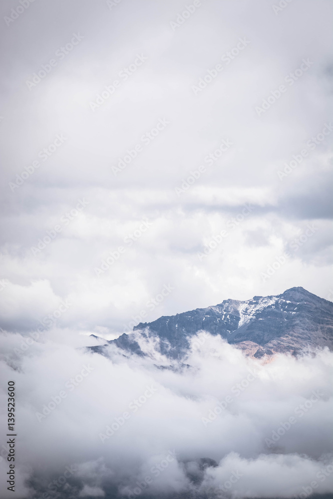 Mountain peak on a cloudy sky. Summer weather in the Peruvian Andes, south of Arequipa.