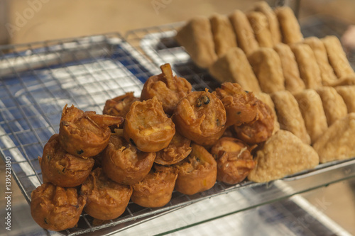 Fried tofu and taro with bean on shelf in street food shop.