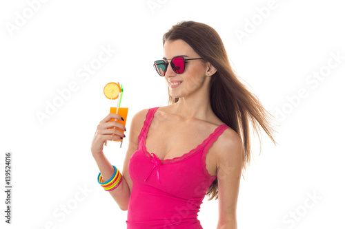 summertime portrait of young gorgeous brunette woman with cocktail in her hands posing isolated on white background