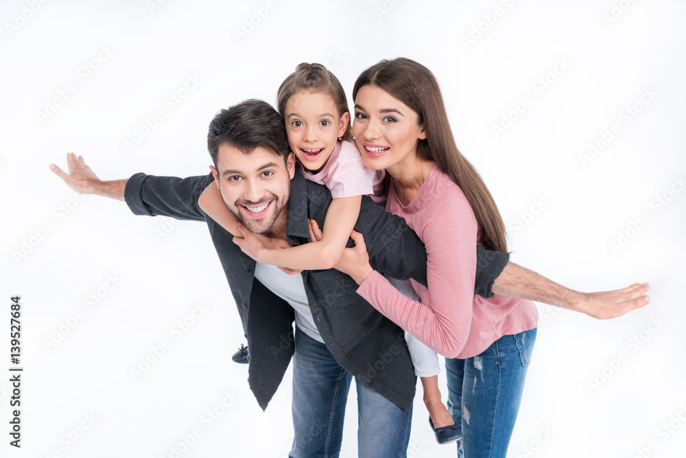Happy young family with one child having fun together on white