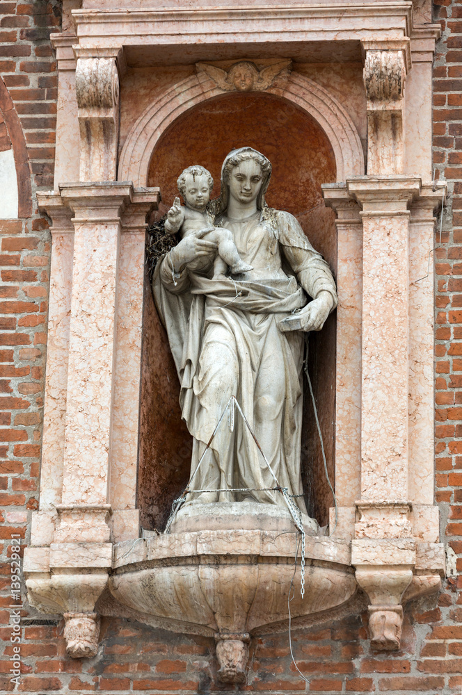 Madonna with child on the wall of The Domus Mercatorum  in Verona. Italy