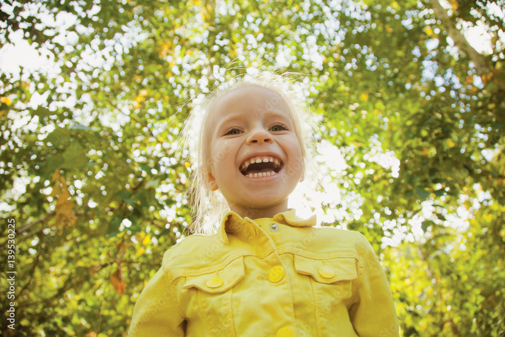 Smiling happy toddler girl. Sunny Autumn day