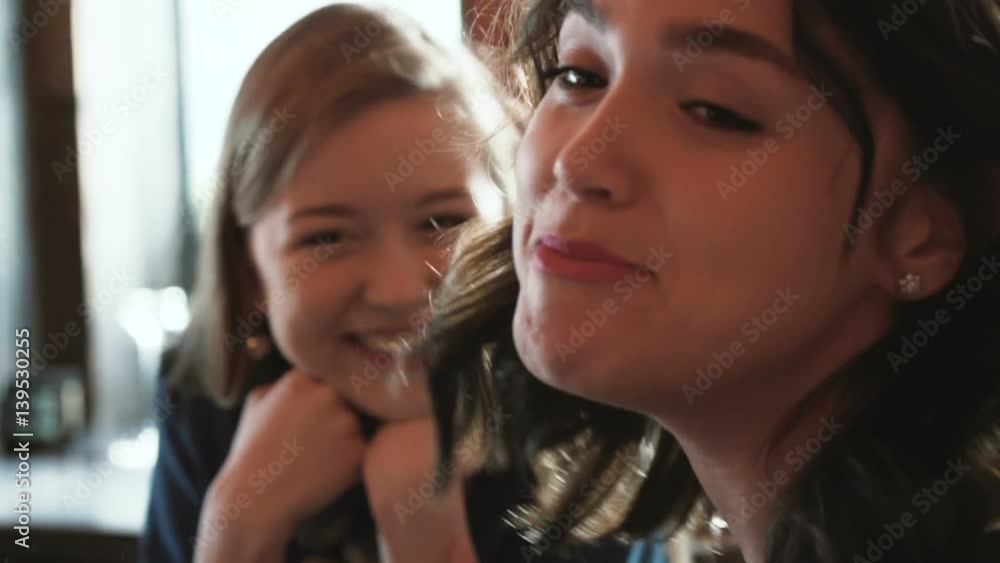 three cute beautiful happy girl smile and laugh, while chatting emotionally in the cafe in the city with cups of coffee during sunny day three cute beautiful happy girl smile and laugh, while chatting emotionally in the cafe in the city with cups of coffee during sunny day