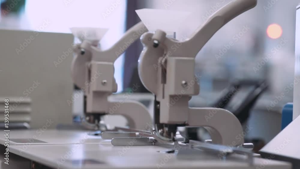 Printing house, a machine for punching eyelets, close-up. 60fps.
Printing house, a machine for punching eyelets, close-up. 60fps.