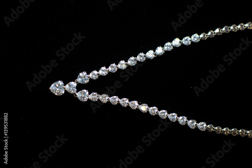 necklaces with precious stones on a black background