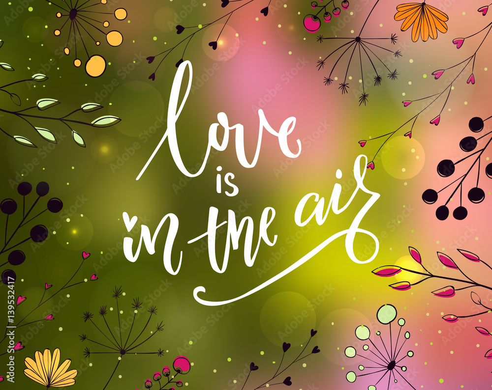Love is in the air - inspirational quote at blurred nature background with plants doodles