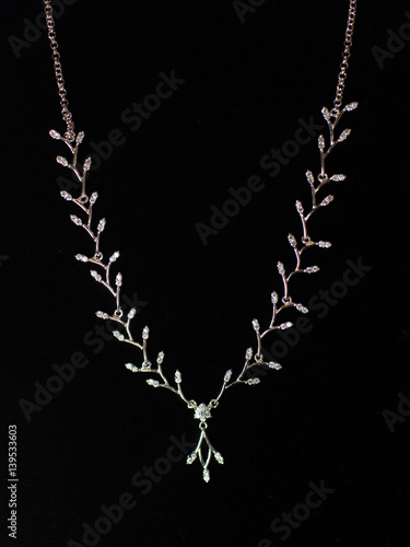 necklaces with precious stones on a black background