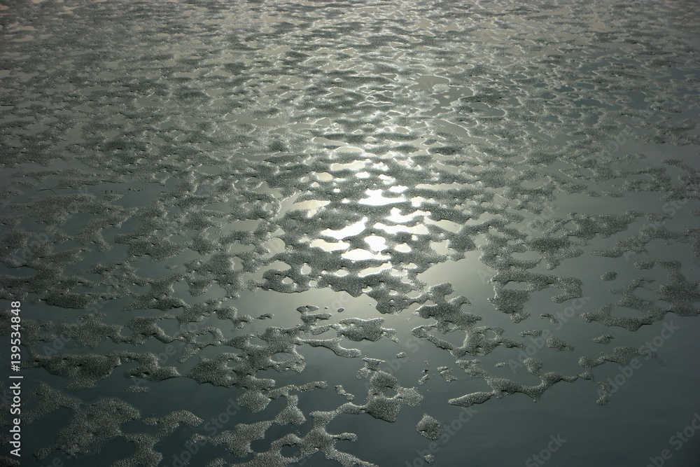 melting of ice at the city lake in the spring