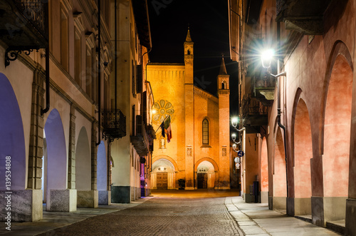 Piazza Risorgimento and via Cavour, main square of Alba (Piedmont, Italy) at night with the facade of Saint Lawrence cathedral