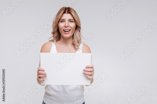 Emotional charismatic young woman looking excited