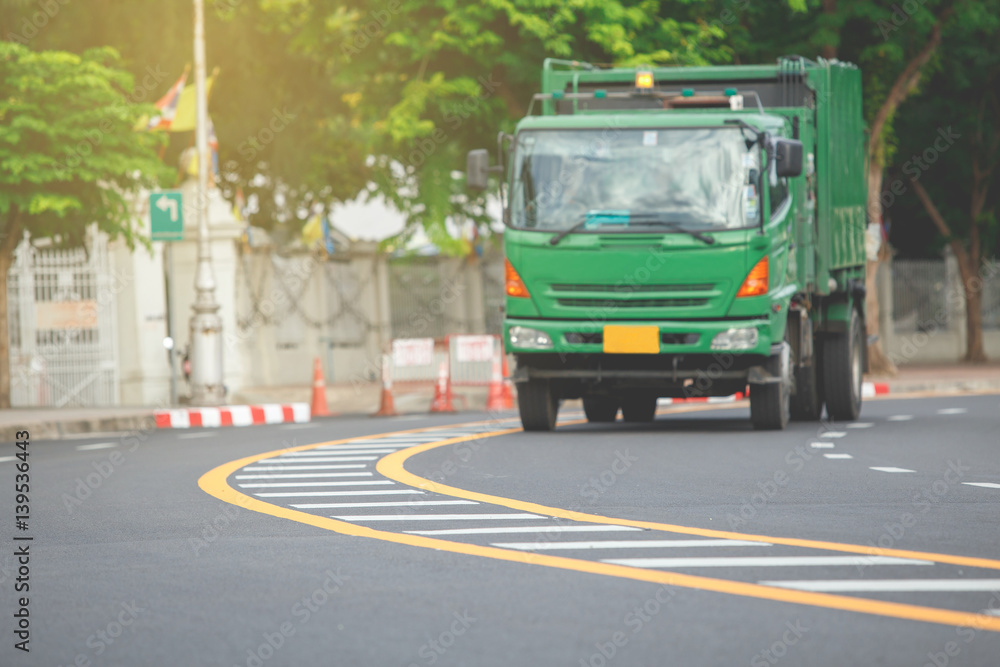 Yellow and white traffic line on the curve road white blur green truck. Yellow and white traffic line on the curve road white blur green truck.