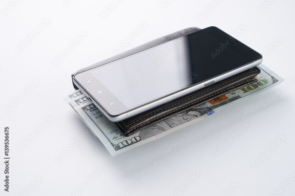 Smartphone and brown leather wallet with US dollar currency isolated on white background. Smartphone and brown leather wallet with US dollar currency isolated on white background.
