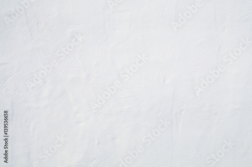 Big whitewashed white painted textured wall background.