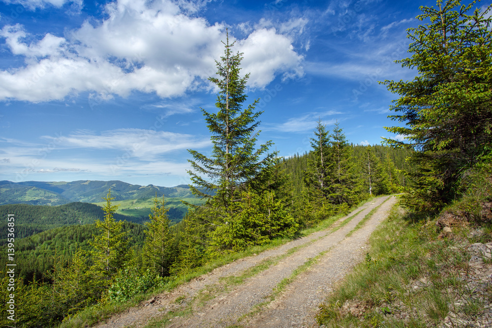 Mountain road and sky with clouds