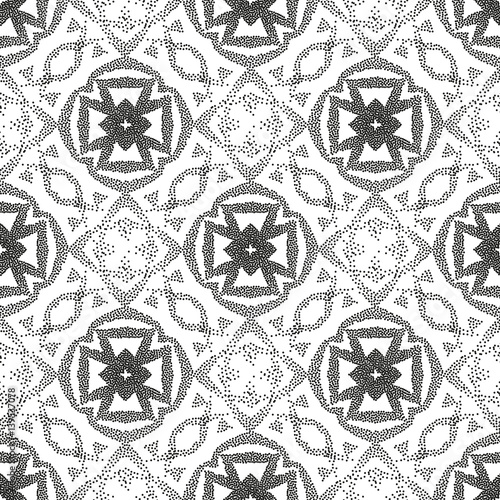 Seamless monochrome ethnic pattern of dots. A pockmarked background of geometric shapes and stylized plant elements.