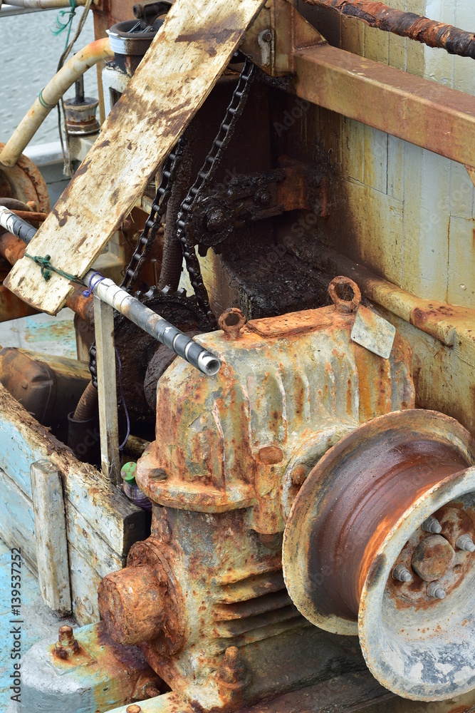 Fototapeta premium Rusty commercial fishing equipment including winch on board of fishing vessel.