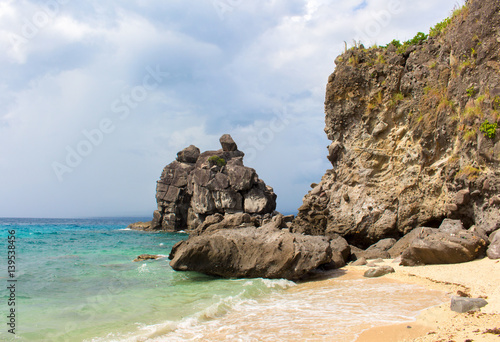 Tropical beach with sand and rocks. White beach and turquoise blue water.