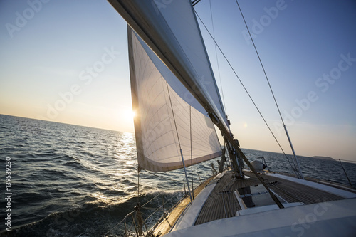 Yacht Sailing In Sea During Sunset
