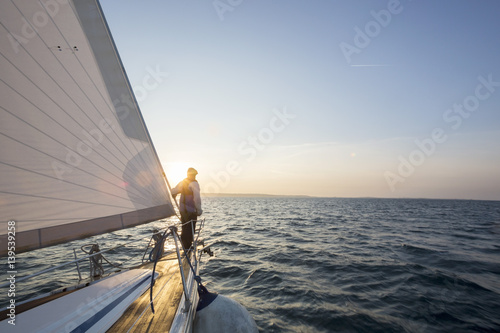 Man Standing On Front Of Luxury Yacht In Sea